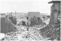 A rubble-littered street in 
Tobruk port