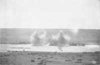 Bombs bursting among 
shipping in Tobruk Harbour, August 1941 (Australian War Memorial)