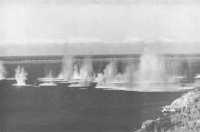 Japanese bombs burst along 
the Port Moresby waterfront (AWM)