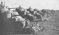 In addition to the militia 
and the returning AIF divisions, the Australian Army possessed its own highly-trained 1st Armoured Division