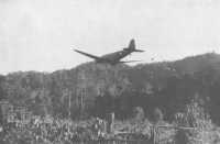 A Douglas transport plane 
drops supplies near Nauro in the Owen Stanleys
