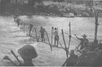 Crossing the Kumusi River 
at Wairopi on a makeshift bridge constructed by Australian engineers
