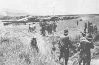 Men of the 2/16th Battalion 
arrive at Kaiapit by plane on 21st September 1943 to begin their advance on foot along the Markham and Ramu Valleys