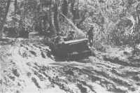 A jeep negotiating mud and 
slush near 9th Division headquarters in the Finschhafen area, 7th November 1943