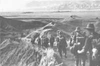 21st Brigade troops 
marching down a winding jeep track in the foothills of the Finisterres on 9th November 1943, after their relief by the 
25th Brigade