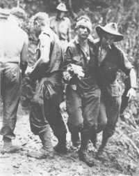 A wounded member of the 
2/16th Battalion being assisted to the RAP