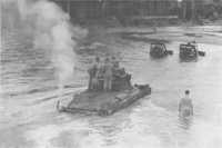 Bulldozers towing a tank of 
the 2/4th Armoured Regiment through the Puriata River on 30th March