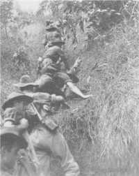 Stretcher bearers of the 
2/2nd Battalion clambering up the 1410 Feature south of Dagua on the way to the forward company, 27th March 1945