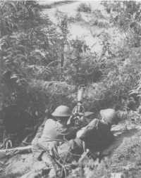 A machine-gun crew of the 
2/23rd Battalion firing at a Japanese position across the Glenelg Highway, Tarakan