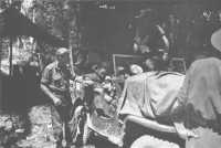 Chinese girl wounded by a 
shell fragment near Labuan airfield being taken to hospital by a jeep ambulance