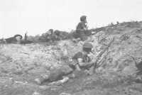 Infantry and artillery 
observers pinned down by Japanese fire from Hill 87, 1st July