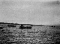view of LCTs and motor 
mine-sweepers passing the Mayu Peninsula on their way to Akyab Island