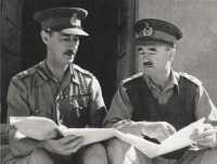 Major-General Scobie 
confers with his predecessor, Major-General Morshead, on taking command of the Tobruk garrison