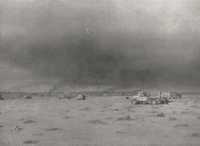The same scene from a 
slightly more comfortable distance, with burning transport of 6 Brigade on the skyline