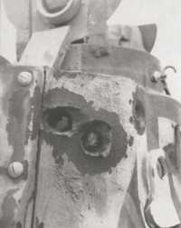 The thick turret of a 
Matilda holed in three places by a German anti-tank gun