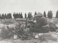 Italians captured in the 
Gazala line march past a much-used Vickers gun