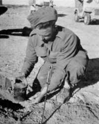 A sapper removes an S-mine 
from a landing field