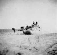 A 1 Armoured Division tank 
moves past a New Zealand medical unit on its way to the Tebaga Gap