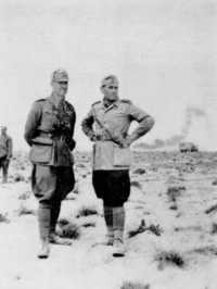 General Mannerini, GOC 
Saharan Group (left), with his Chief of Staff at Divisional Headquarters, 8 April 1943