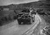 Vehicles of the Divisional 
Cavalry make their way over muddy roads to the Sangro