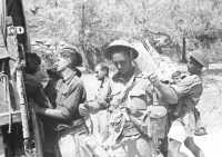 New Zealand infantrymen 
return to their transport after driving the Germans off the high ground around Monte Lignano