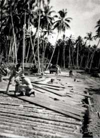 Solid Mahogany Planks cover 
a bridge decked with coconut logs over Joroveto River, Vella Lavella