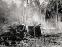 A 25 pounder damaged by 
enemy mortar fire, Falamai