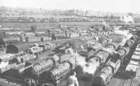 Locomotives, tank cars, 
and freight cars are checked at an Army railway shop before being stockpiled for use on the Continent