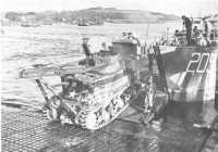 Waterproofed tank recovery 
vehicle moving from a “hard” onto a landing craft