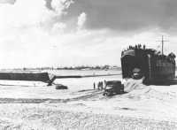 Dried-out LST discharging 
its cargo at OMAHA Beach