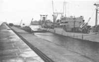 The First POL Tanker 
alongside the Digue de Querqueville, Cherbourg, 25 July 1944