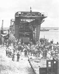 Seatrain unloading a 
gondola onto rail lines laid to the water’s edge, Cherbourg, August 1944