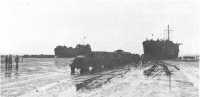 LSTs discharging cargo on 
the beach at St