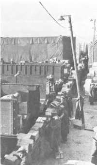 Italian service unit men 
loading cases of rations at a Quartermaster Depot near Marseille
