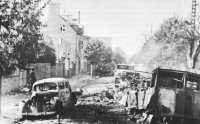 Destroyed enemy vehicles 
cluttering a street in Avranches