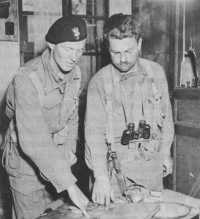 A Polish Soldier (left) and 
an American officer confer near Chambois