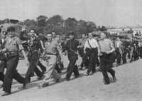 French Resistance Fighters 
march in a Paris liberation parade