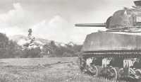 320th Infantry are 
supported by a tank which fires on village from across the canal