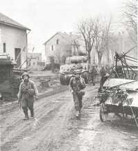 Entering the outskirts of 
Metz, men of the 378th Infantry are shown on the morning of 17 November in pursuit of the enemy along roads strewn with 
abandoned equipment