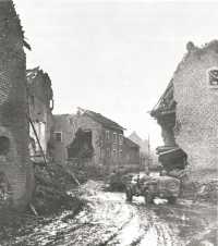 Jeeps driving through 
Dieuze with troops of the 4th Armored Division on their way to the front