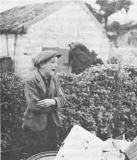 German boy weeps over the 
few possessions saved from his home outside Aachen