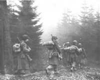 Troops of 325th Glider 
Infantry Moving through Fog to a New Position