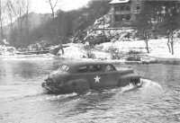 Car Bearing General Bradley 
Fords a Belgian River