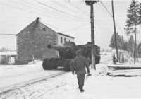 Prime Mover towing an 
8-inch Howitzer along a road near Manhay