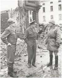 Generals Eisenhower, 
Bradley, and Patton confer in the Ardennes