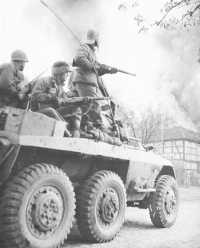 Infantrymen ride an armored 
car in the race to the Elbe