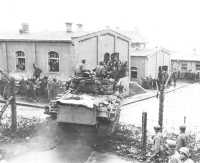 A tank of the 14th Armored 
Division enters the prisoner-of-war camp at Hammelburg