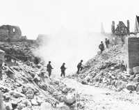 A patrol of the 3rd 
Division makes its way through the rubble of Nuremberg