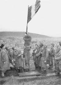 French troops raise 
Tricolor over Chateau de Belfort, November 1944