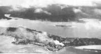Tulagi Island, framed 
against the background of the larger Florida Island, is fire-swept from the hits scored by American carrier 
dive-bombers